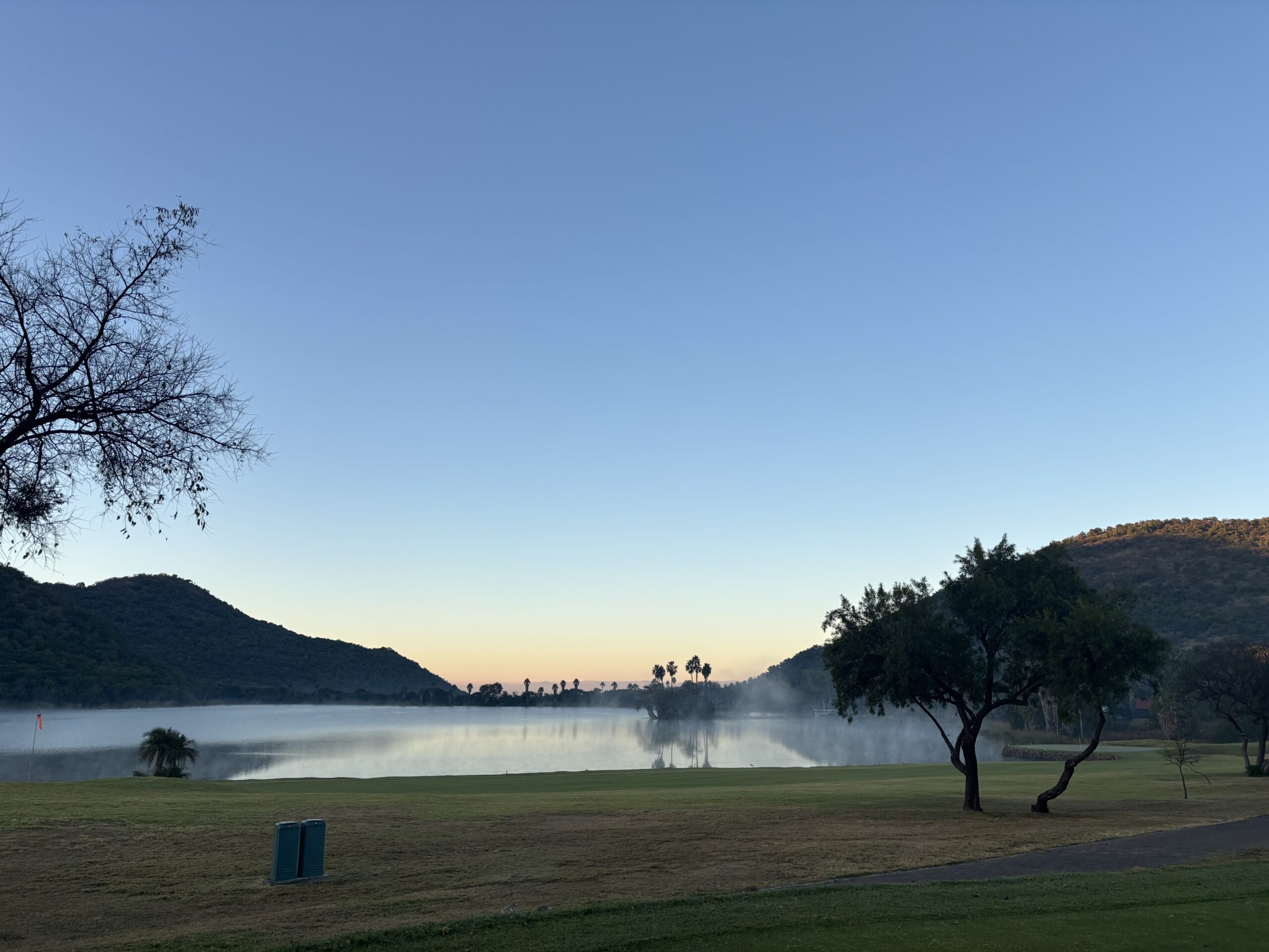 Mist rising from the Sun City lake at dawn.